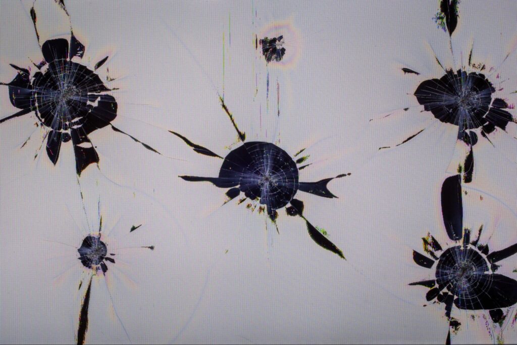 Impact marks and cracks on an LCD screen.