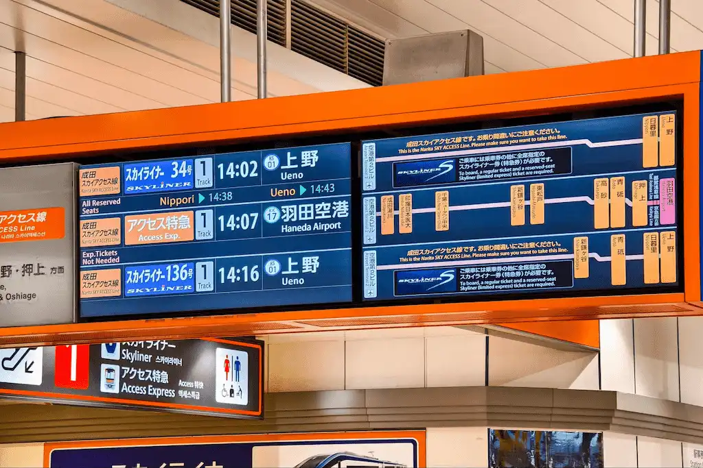 Digital signage display at train station showing departure times and destinations
