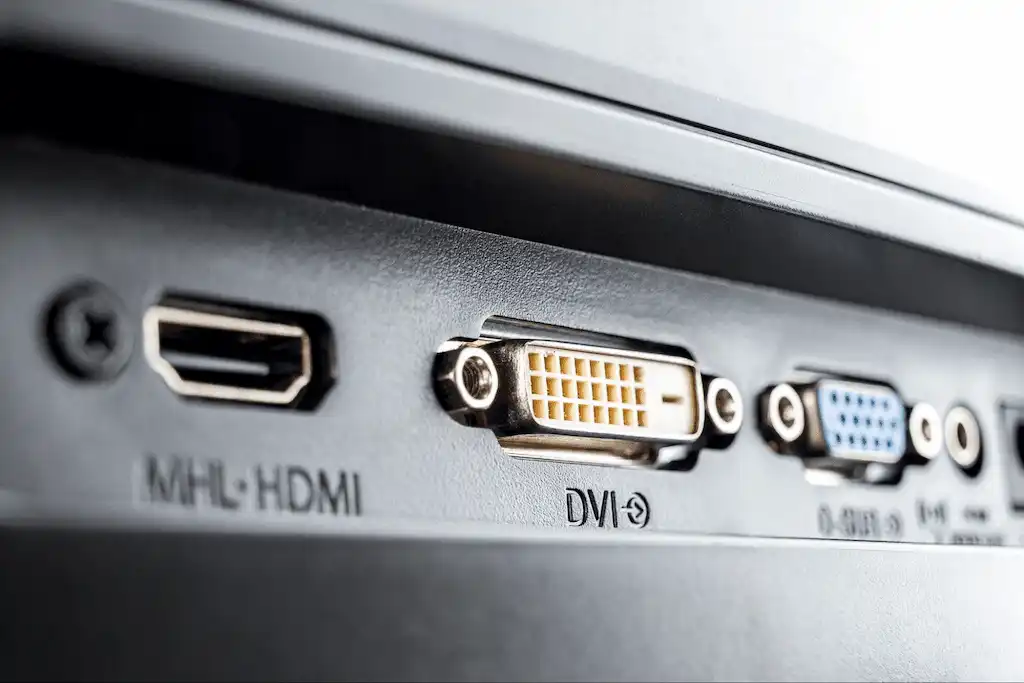 Close-up of HDMI, DVI, and VGA ports on the back of a monitor or computer.