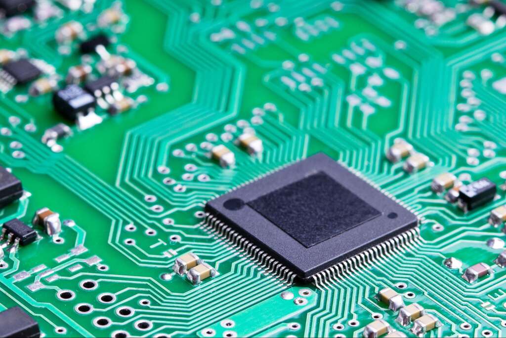 Close-up of a microcontroller chip mounted on a printed circuit board with electronic traces and components